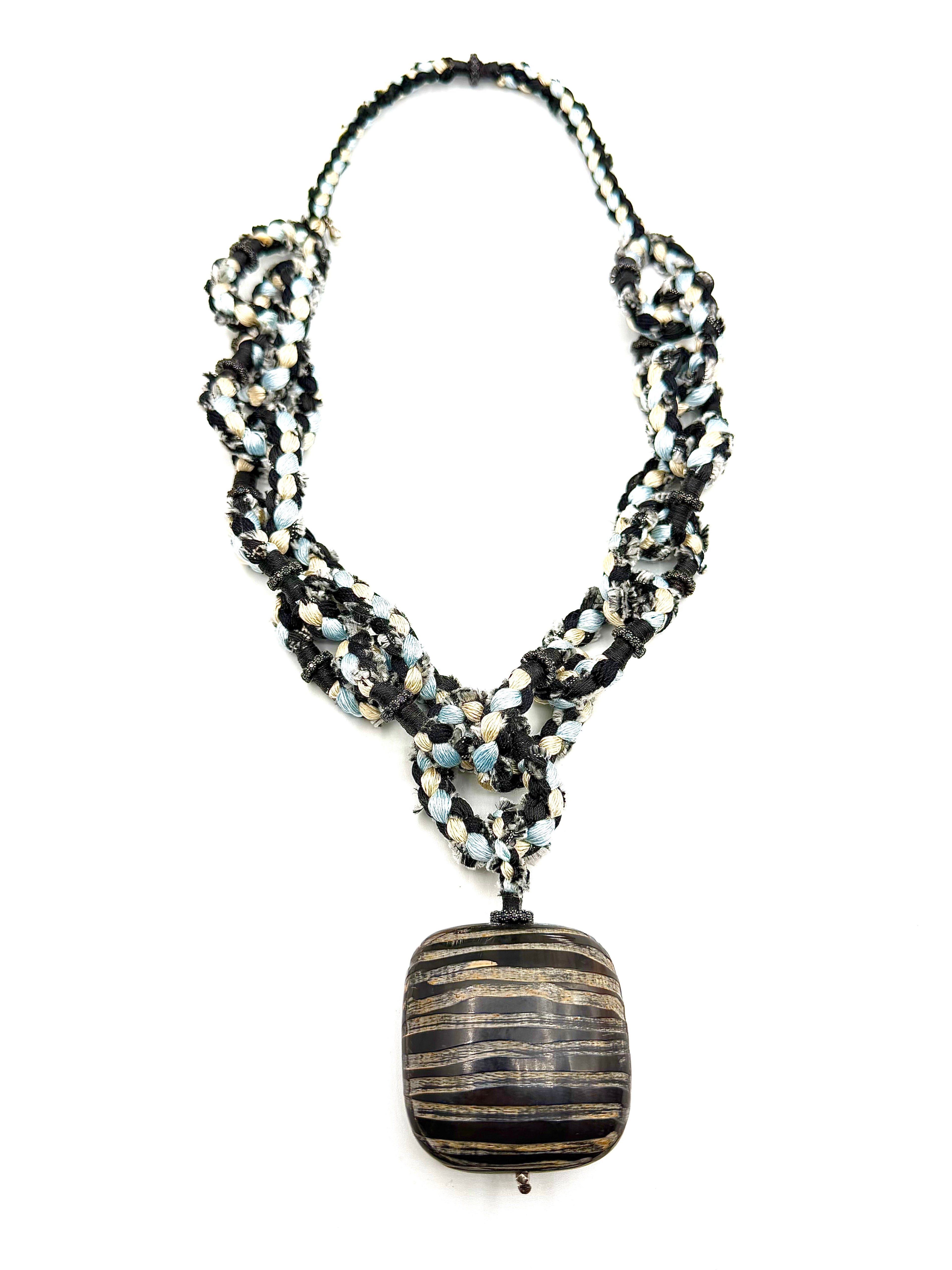 # 1 Handwoven Silk thread and a sculptured horn pendant come together in a One of Kind Necklace hand crafted by Pera Jewelry