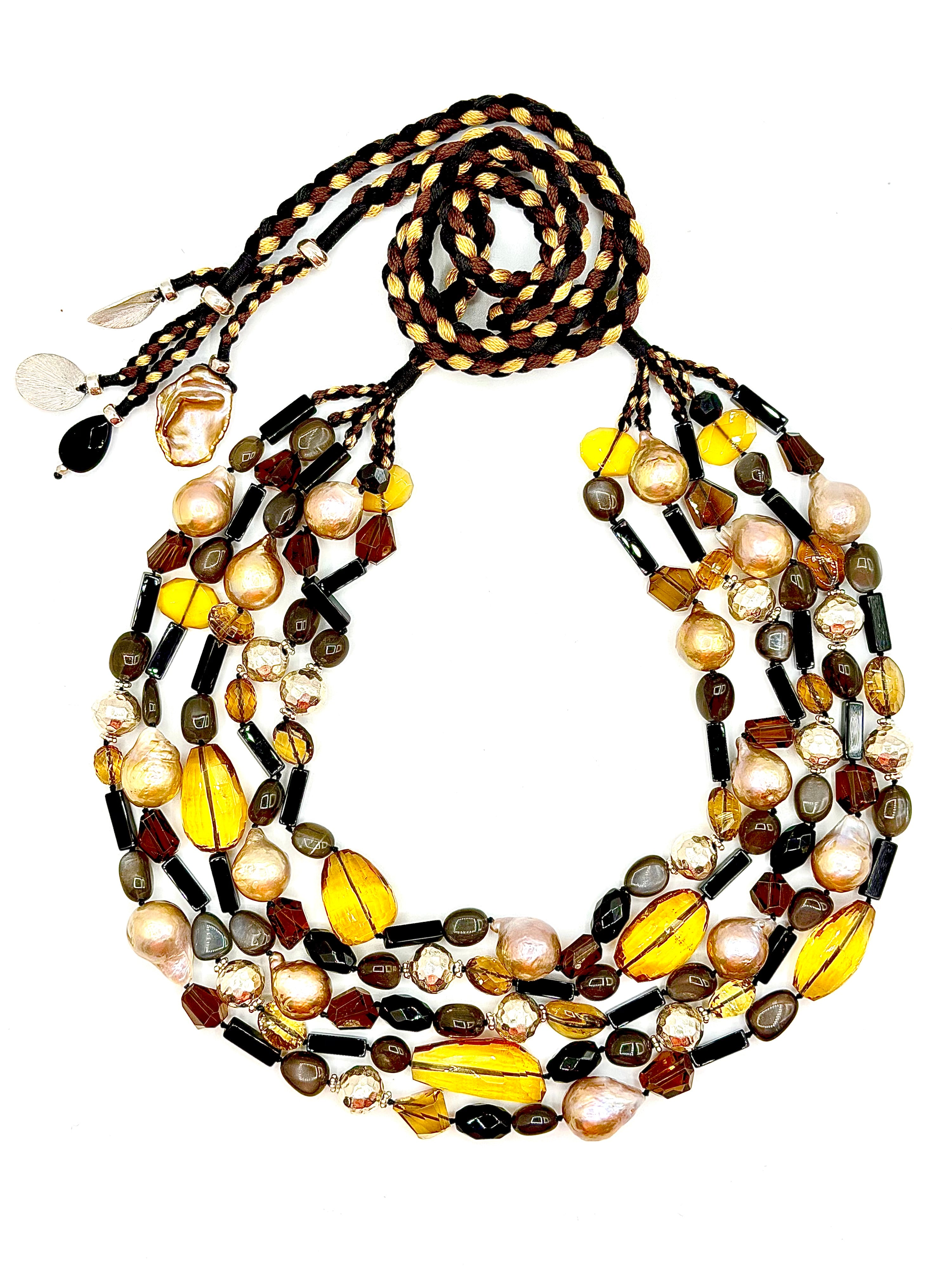 # 1 The Perfect balance of of bold beauty , natural gemstones , and golden refinement . Five Strands of Timeless Beauty ; Onyx , Quartz & Baroque Pearls